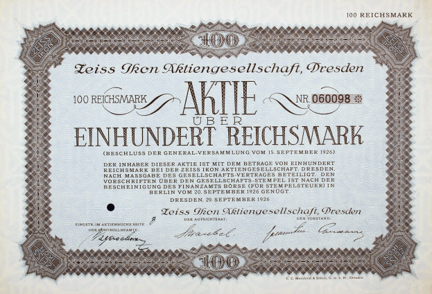 Altes deutsches Aktienzertifikat für 100 Reichsmärker mit schwarzem Rand und deutschem Text.