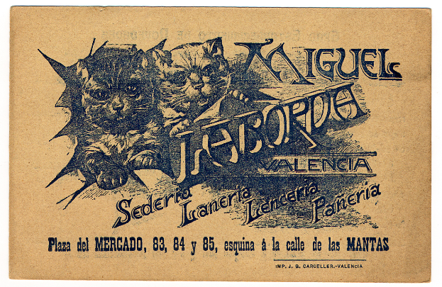 Ein altes Geschäftsblatt mit einem Foto von zwei Katzen und einem Text, der die Katzen beschreibt.